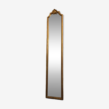 Old vertical gilded mirror with hood