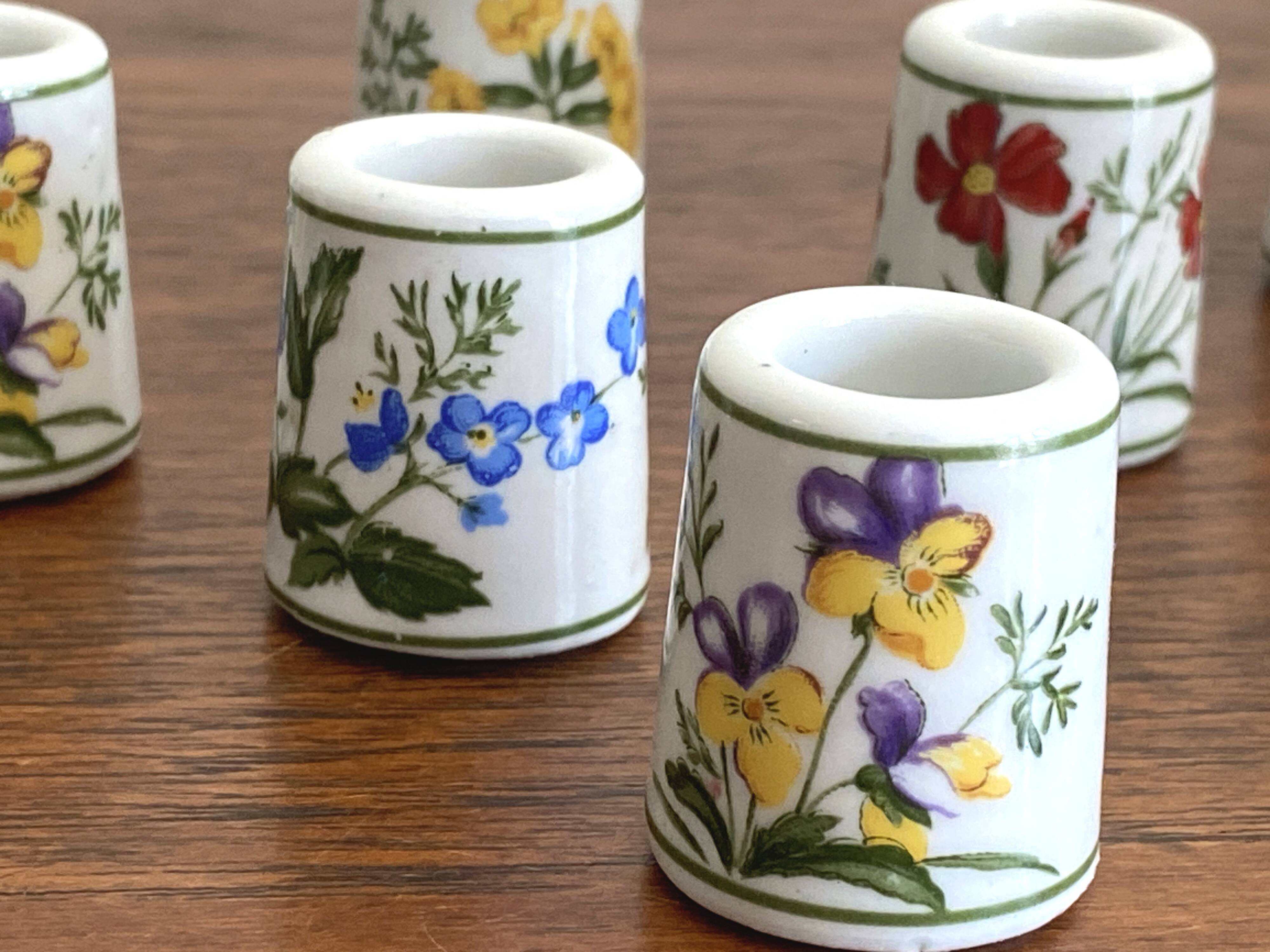 Set of 9 mini vintage porcelain candle holders decorated with spring flowers.