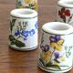 Set of 9 mini vintage porcelain candle holders decorated with spring flowers.