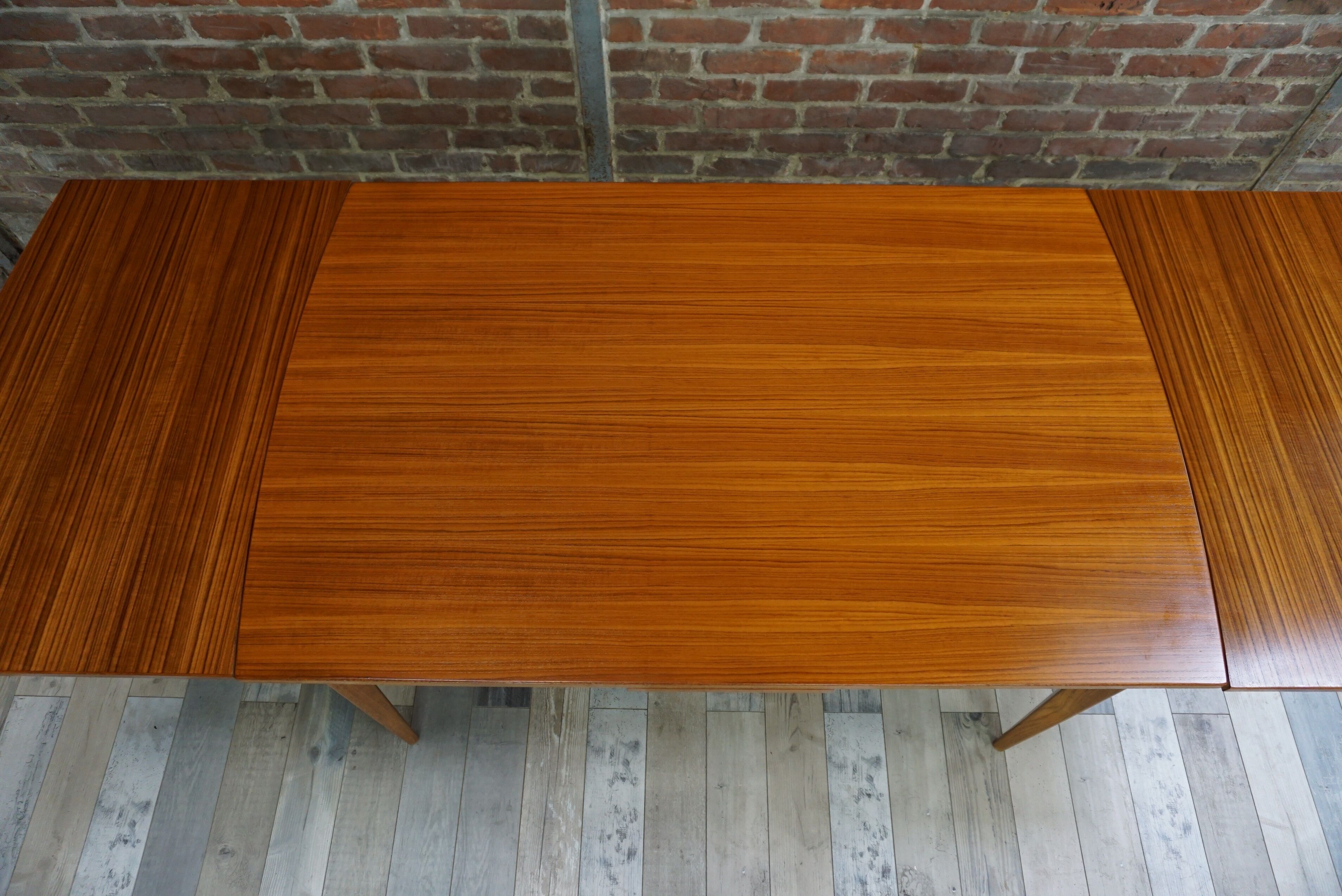 Teak dining table design by Johannes Andersen for Samcom 60s