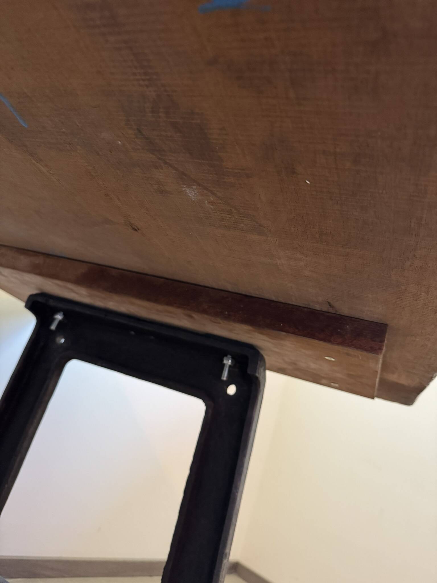 Industrial style table with a mahogany top.