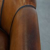 Unique vintage cognac-coloured leather club armchair with black piping
