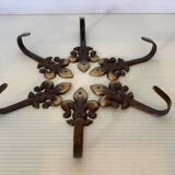 Six metal fleur-de-lys hooks
