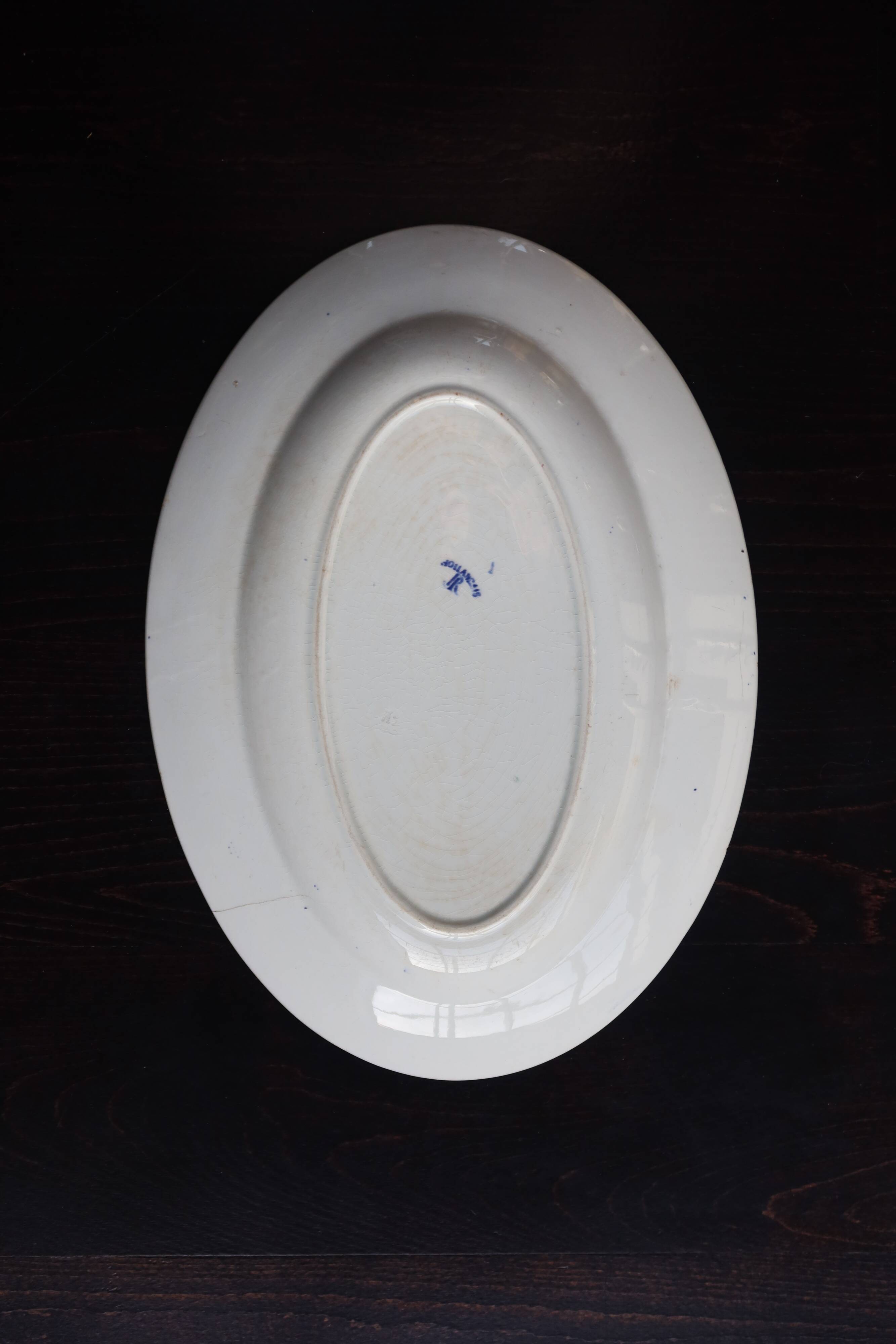 Antique serving dish in white and blue earthenware.