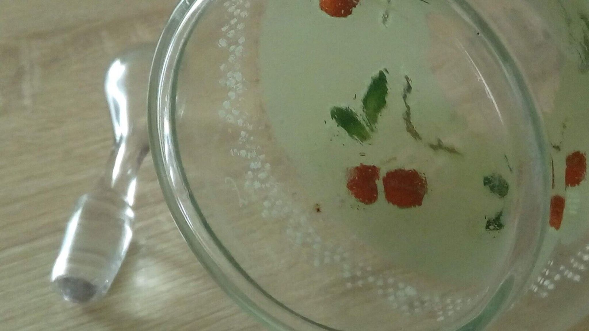Glass carafe with enamel decoration of cherries.