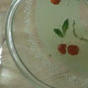 Glass carafe with enamel decoration of cherries.