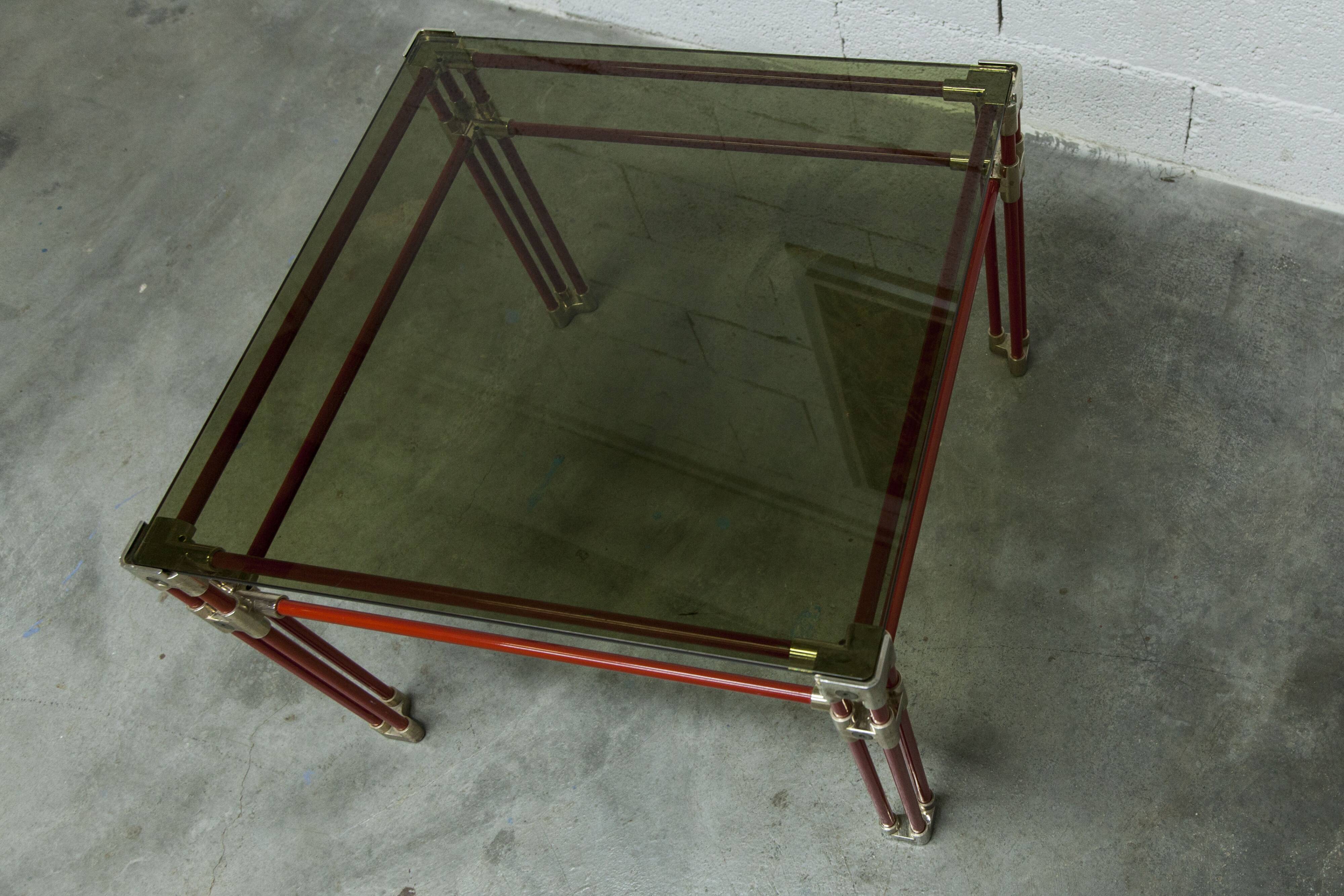 Postmodern Italian design coffee table in smoked glass with red steel structure