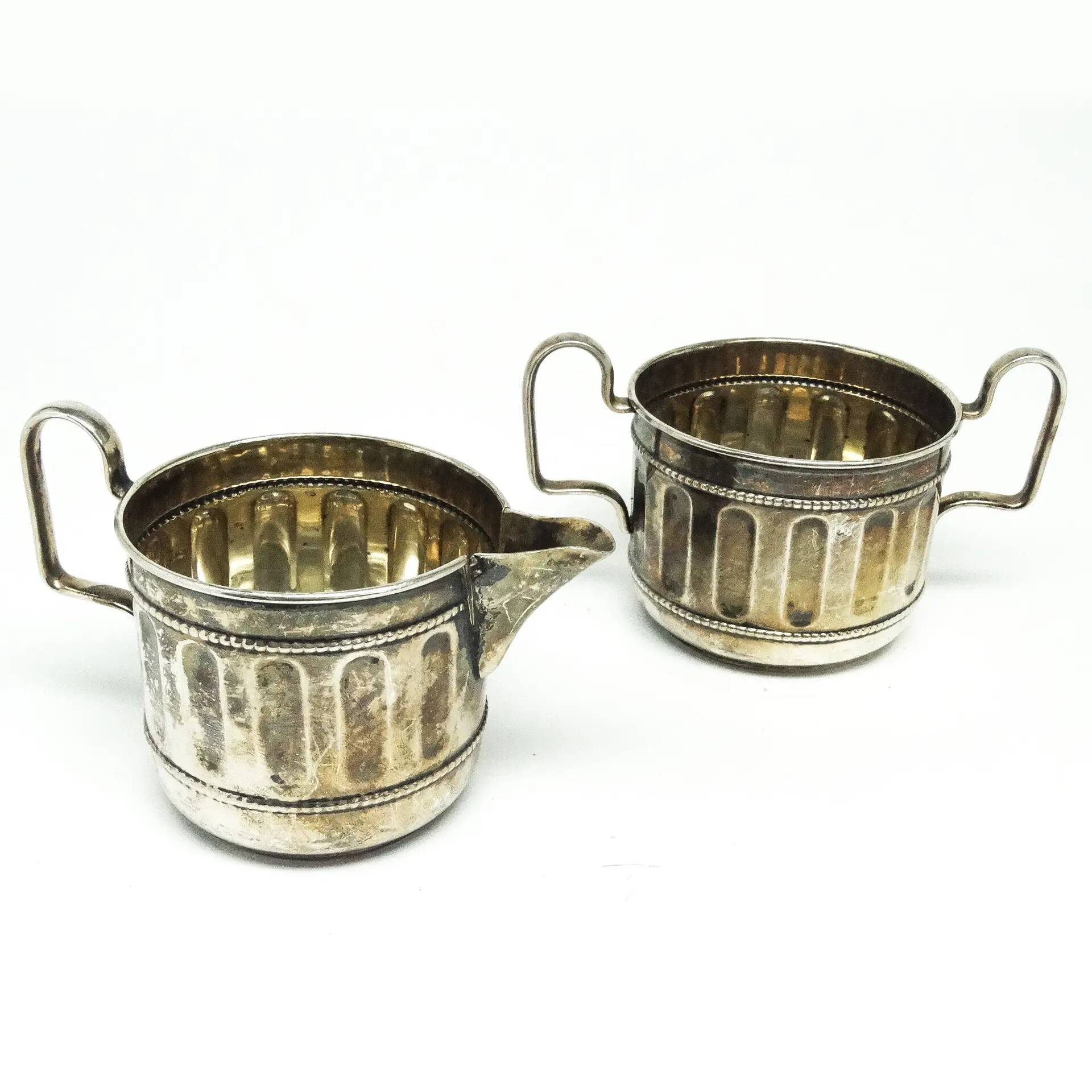Set of sugar bowl and milk jug, neoclassicism with art deco influences, silver-plated brass, Belgium, 1930s.