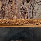 Wooden mirror decorated with gold from the 1920s