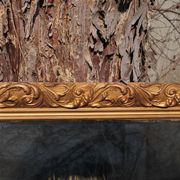 Wooden mirror decorated with gold from the 1920s