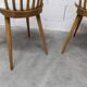 Pair of Baumann Menuet chairs, Honey patina, White skai seat