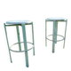 Pair of green factory-style bar stools.