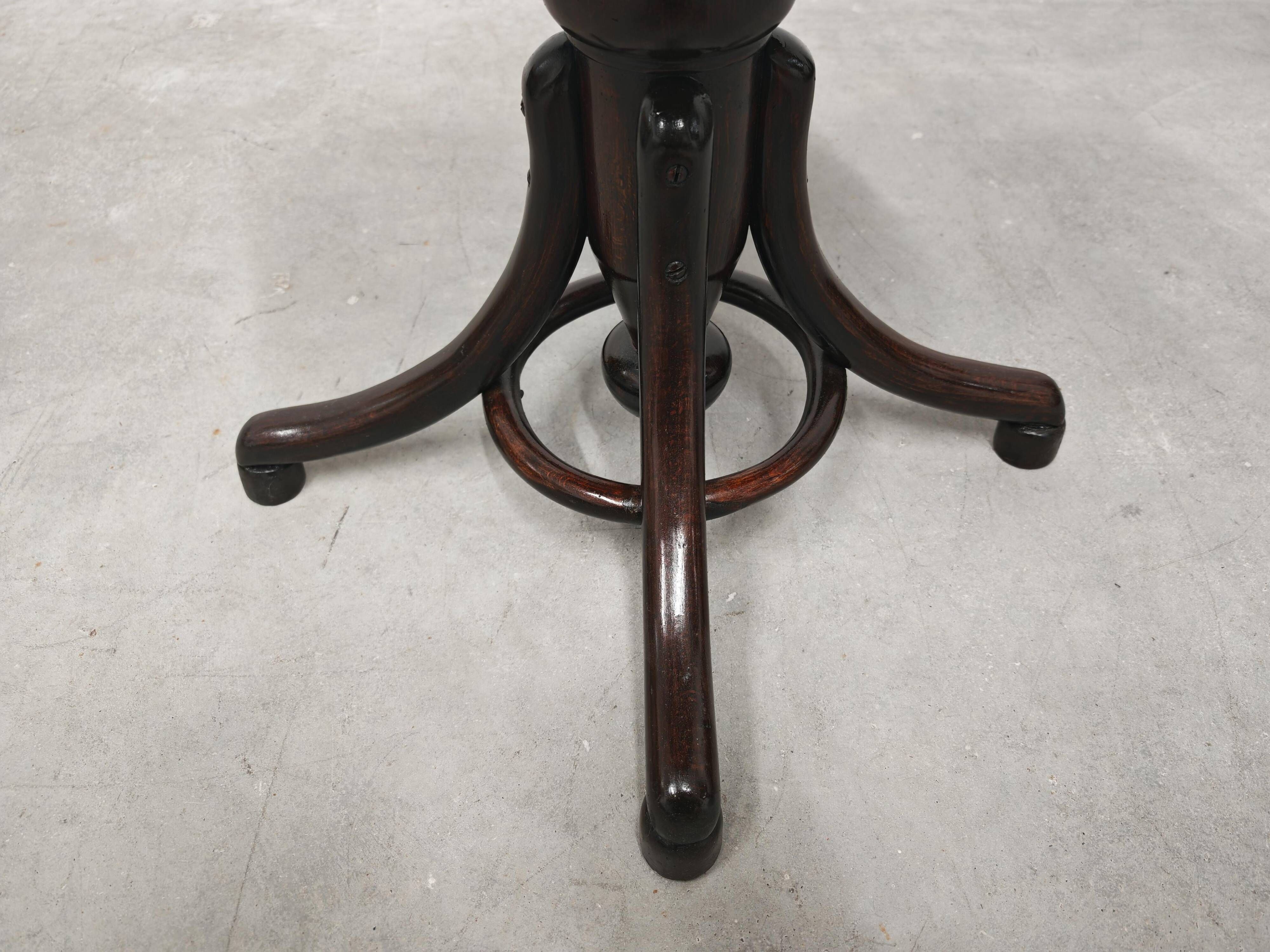 Antique curved wooden piano stool with kilim fabric from the 1910s.