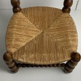 Brutalist wood turned bobbin low rush chair in the style of Charles Dudouyt