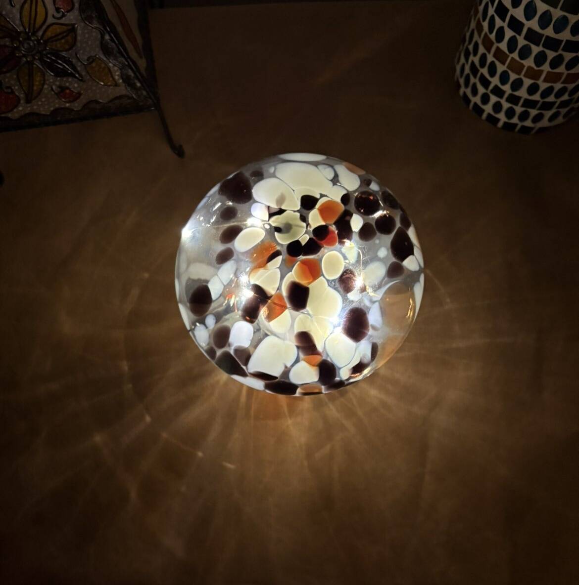 Mosaic glass mushroom lamp in black, white, and amber.