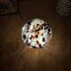 Mosaic glass mushroom lamp in black, white, and amber.