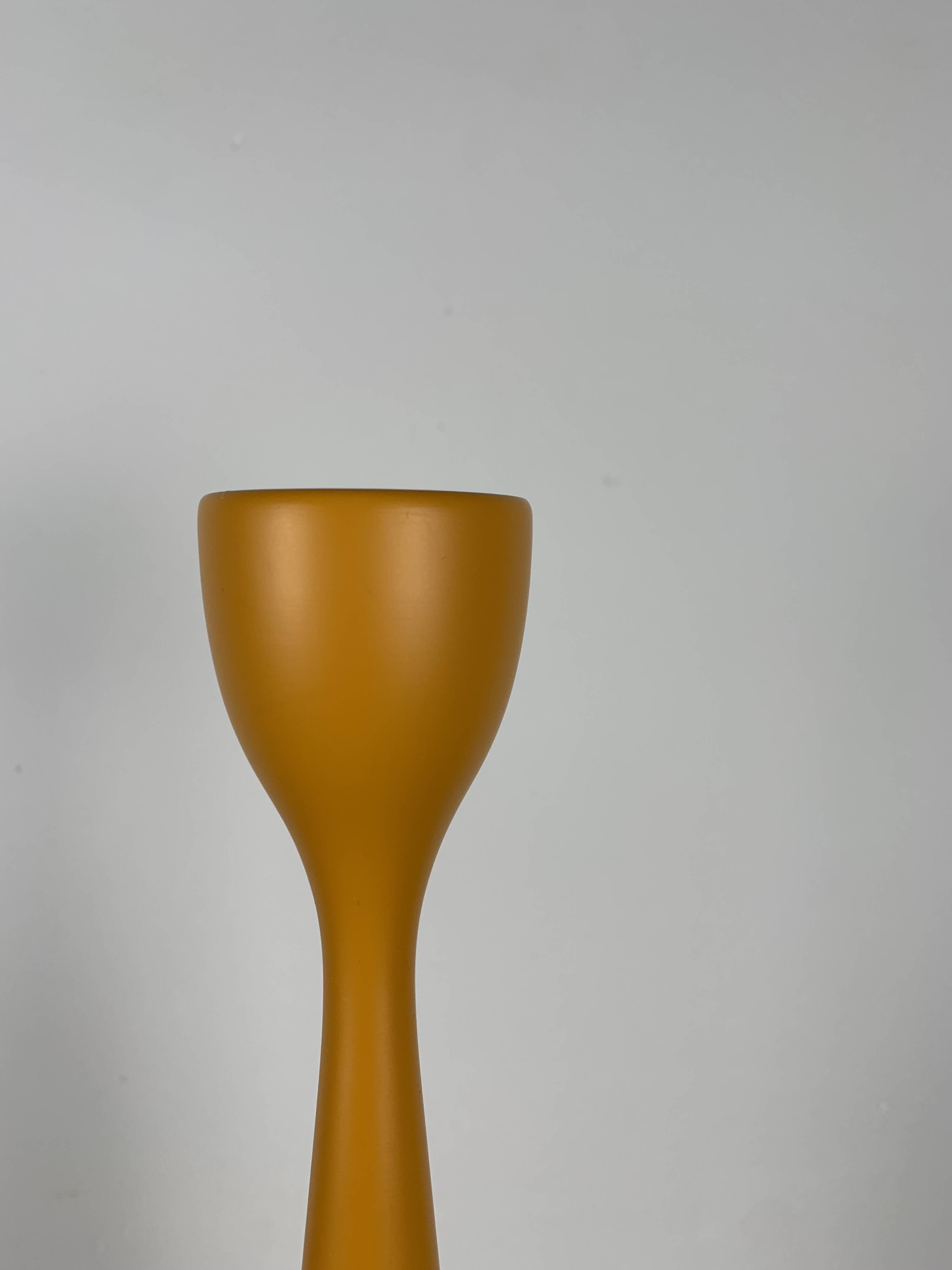Large candle holder in orange-yellow lacquered wood