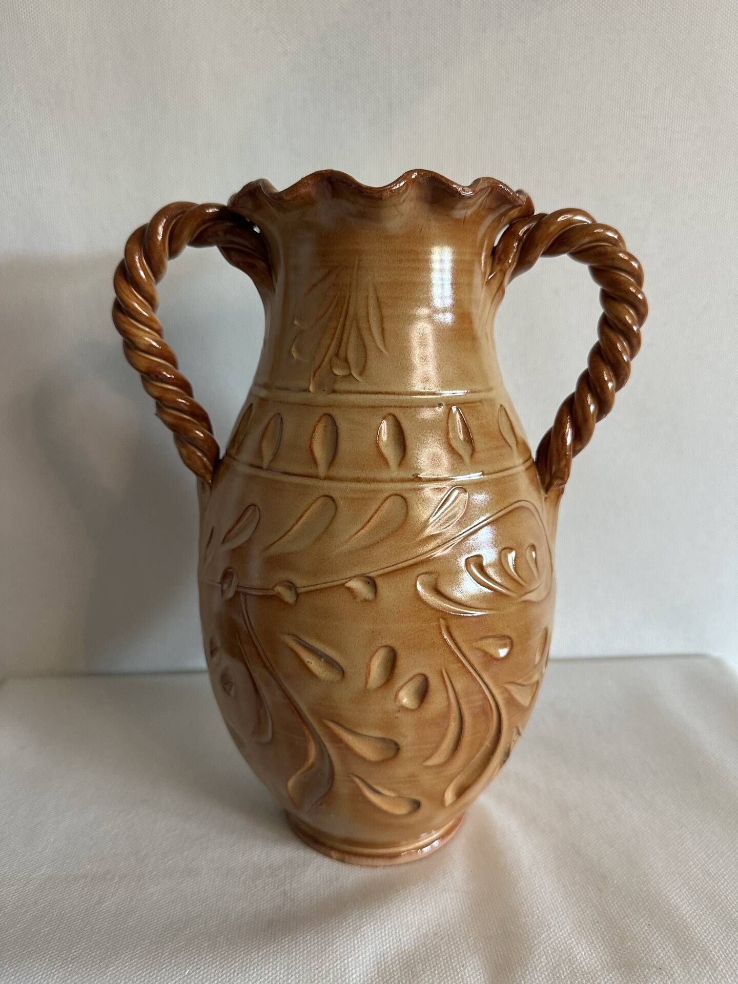 Large antique ceramic vase with two twisted handles.