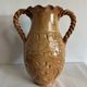 Large antique ceramic vase with two twisted handles.