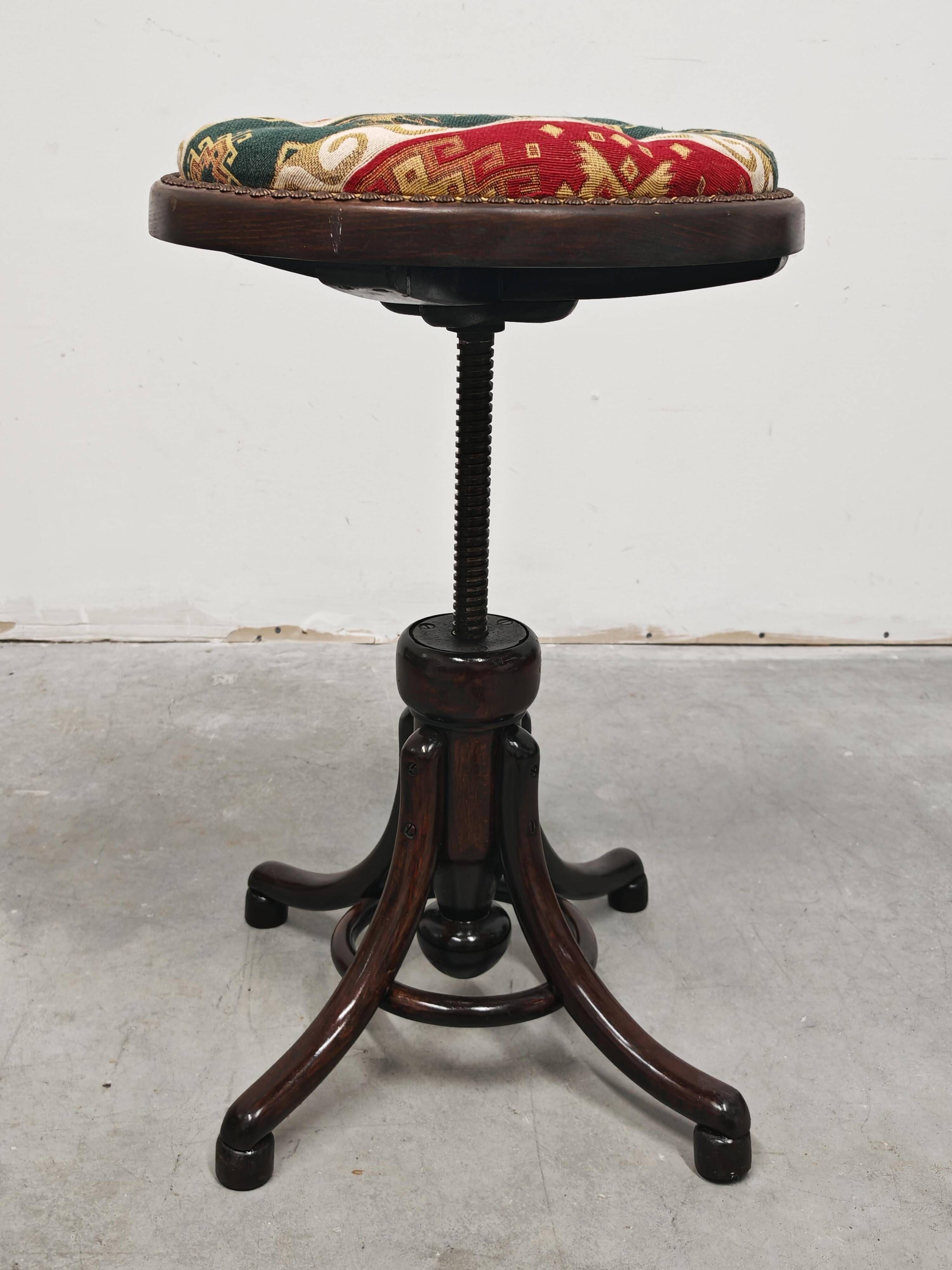 Antique curved wooden piano stool with kilim fabric from the 1910s.