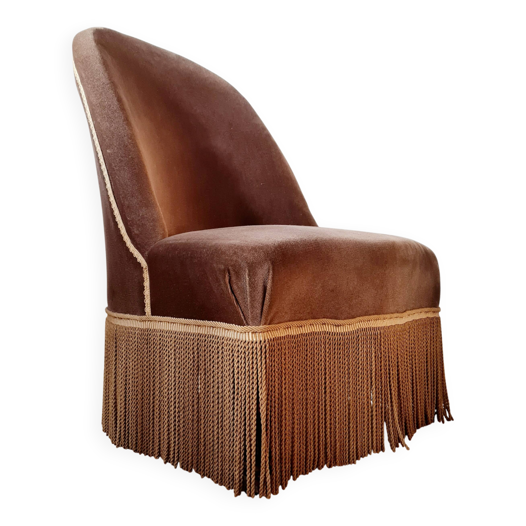 Brown velvet crapaud armchair with fringes and sculpted legs.