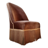 Brown velvet crapaud armchair with fringes and sculpted legs.