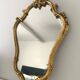 Old golden mirror in composite resin baroque style 60s