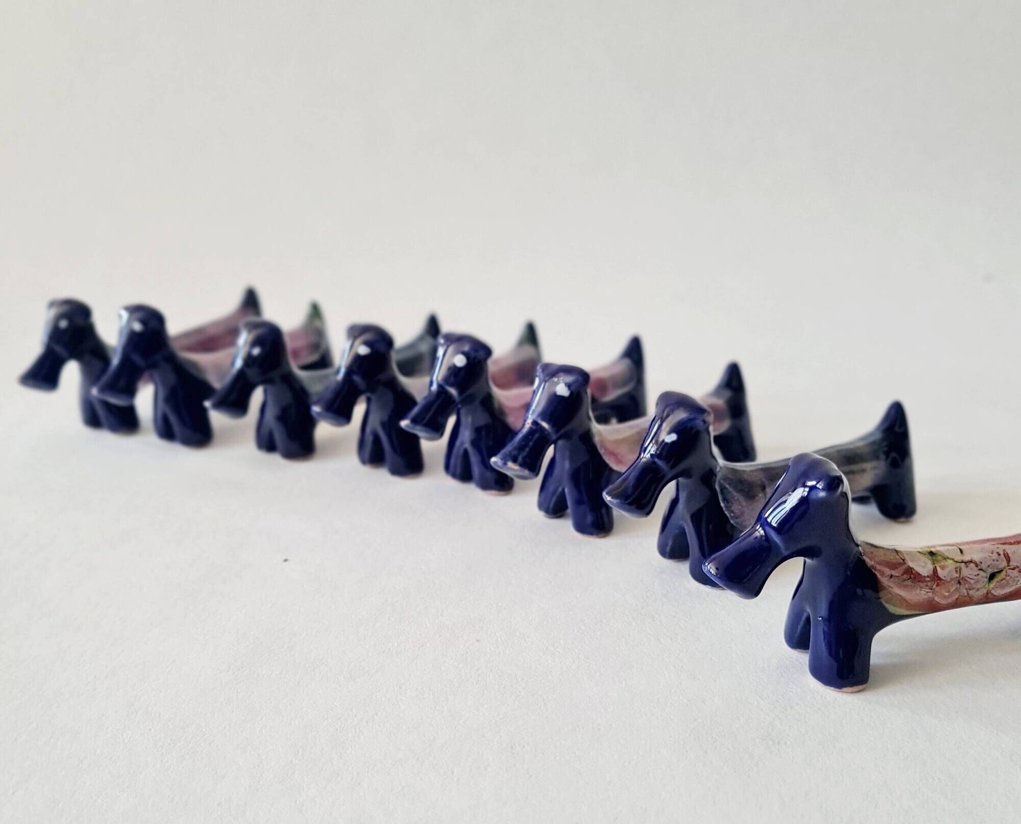Set of 8 vintage ceramic knife rests, retro dog design.
