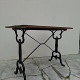 Solid oak bistro table with a cast iron base, signed.
