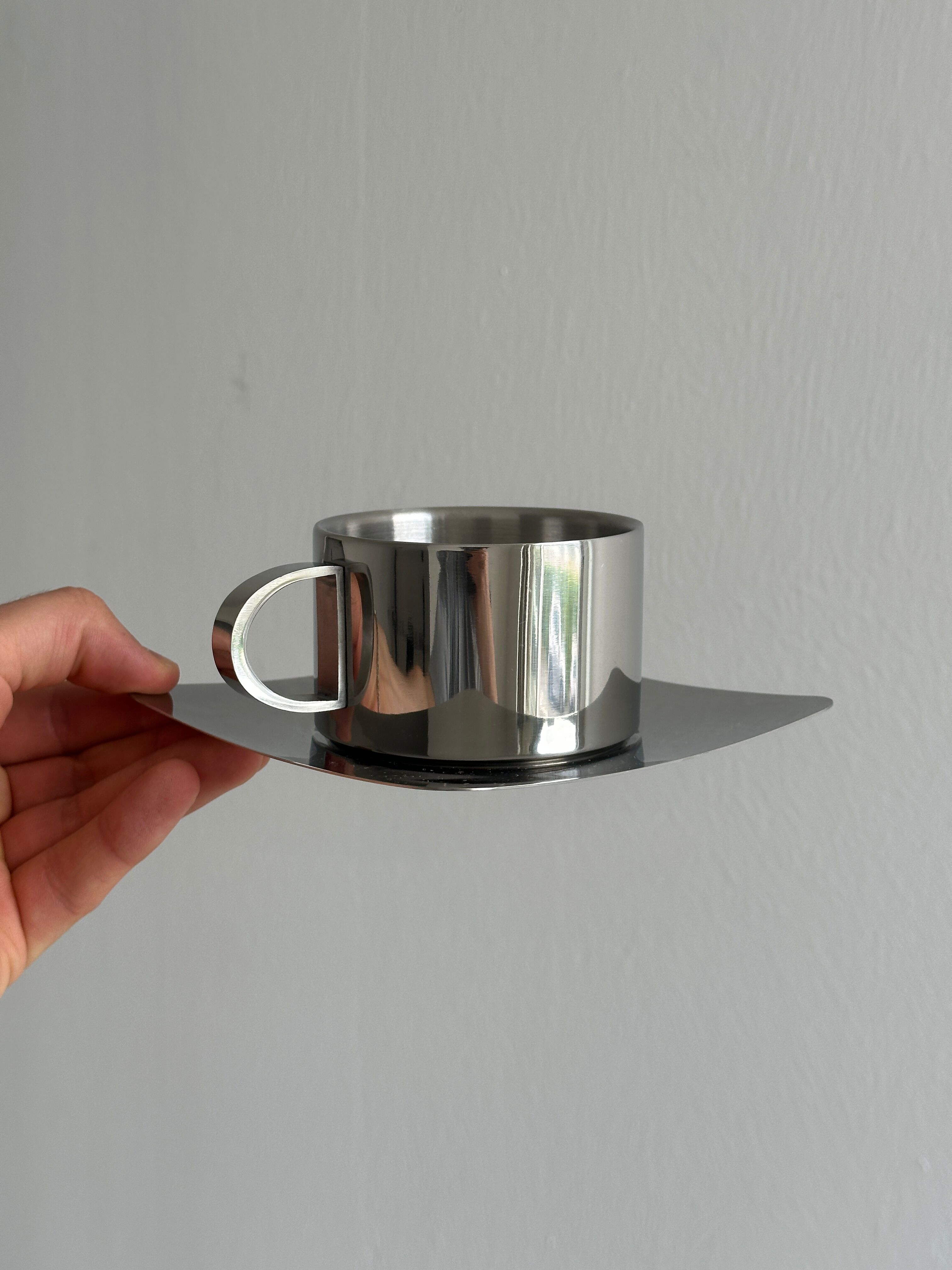 set of 4 stackable stainless steel coffee cups with saucers