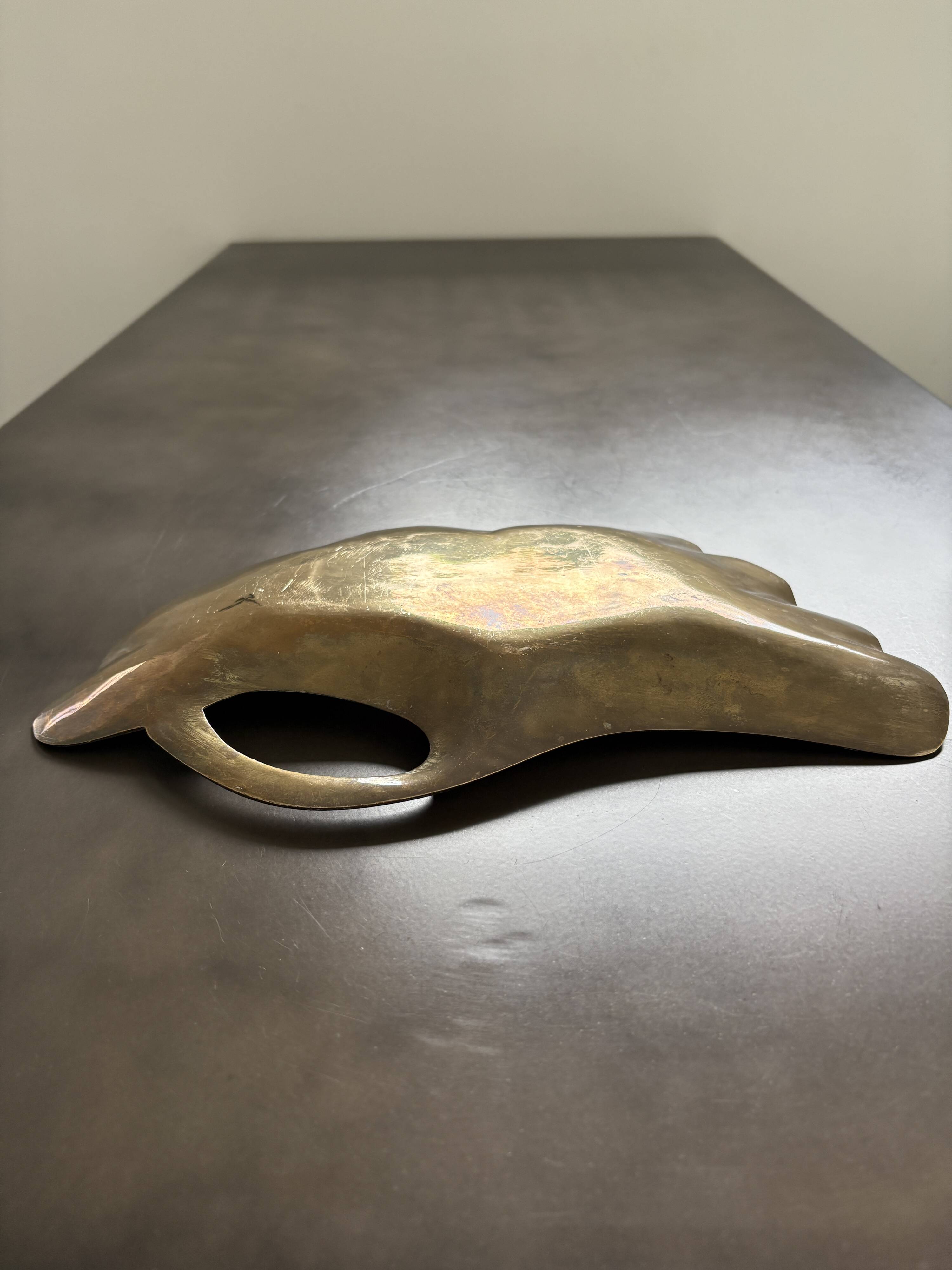 Old brass pocket emptier