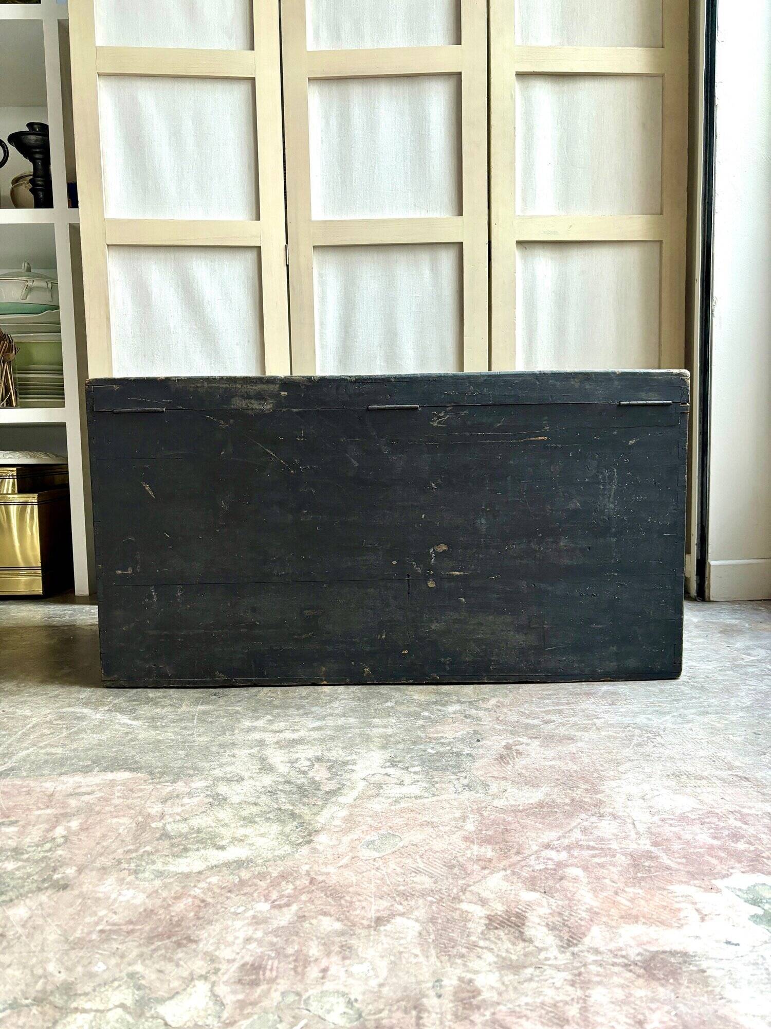 Trunk, black wooden chest and wallpaper