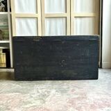 Trunk, black wooden chest and wallpaper