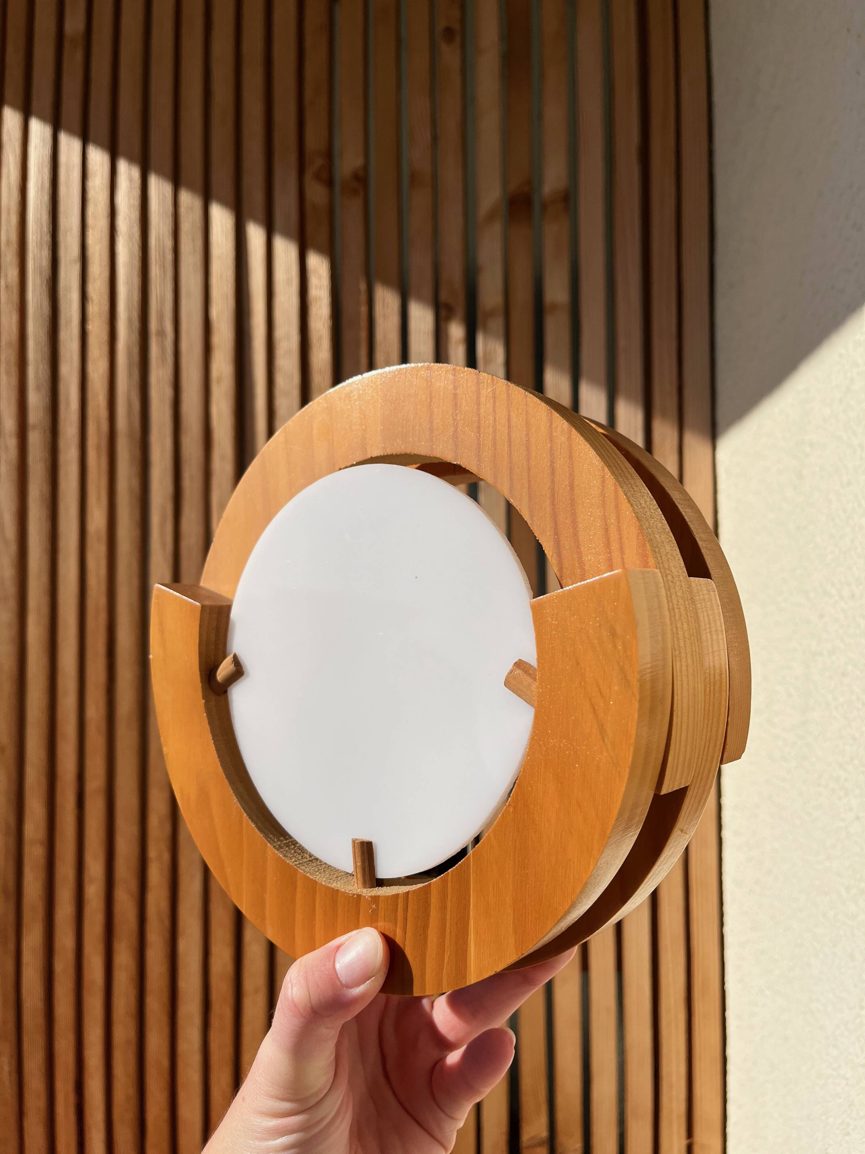Round pine and plexiglass wall light, 1970s