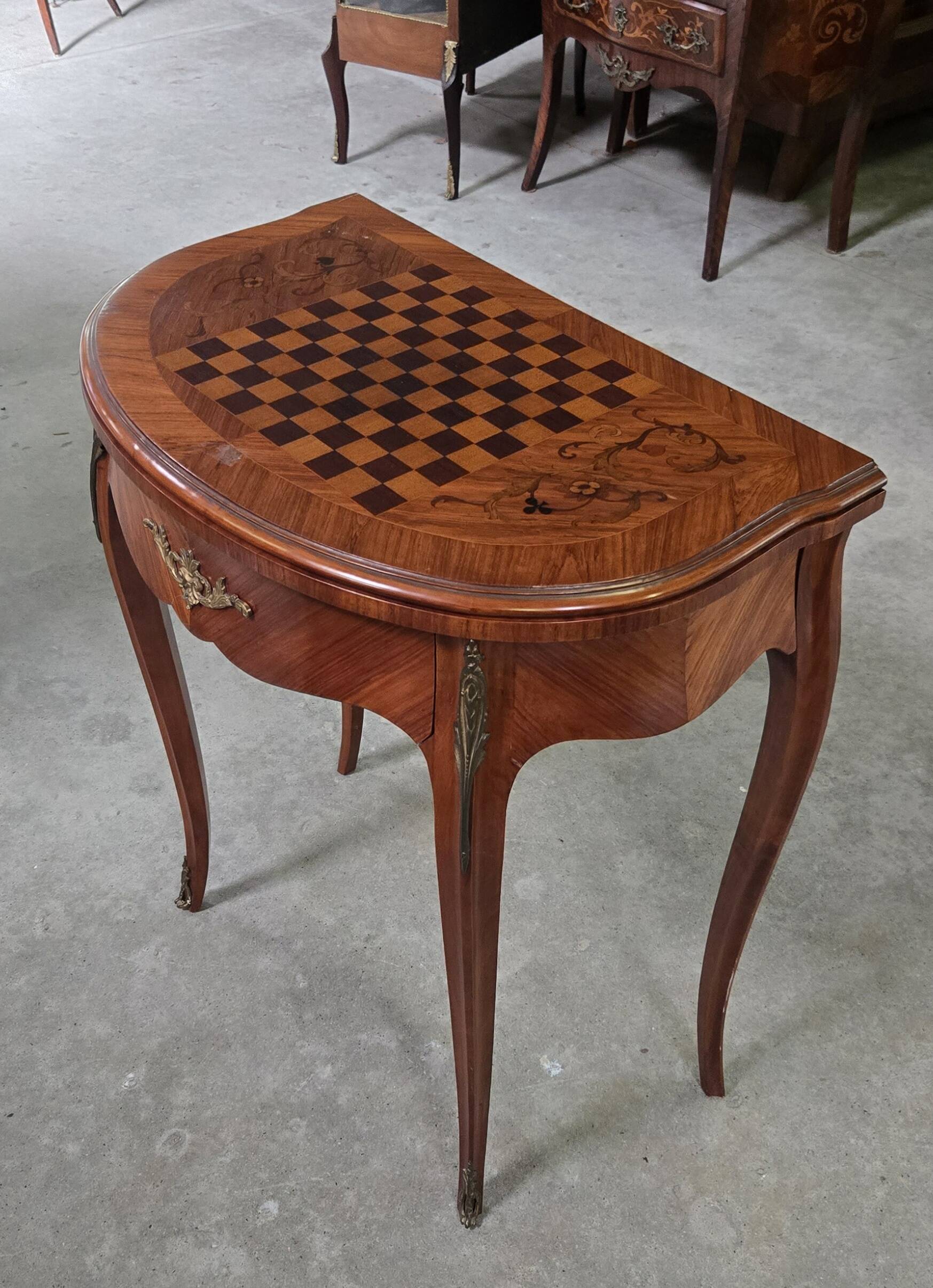 Half-moon gaming table in Louis XV style, made of precious wood marquetry.