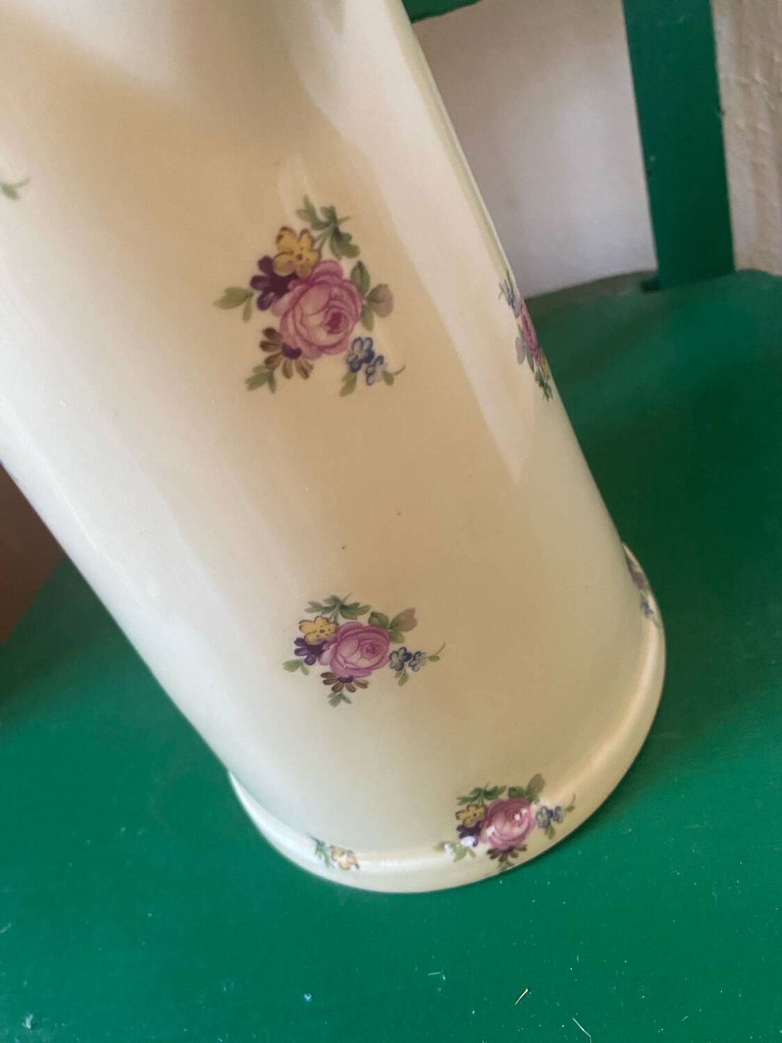 Old flowery and gilded pitcher.