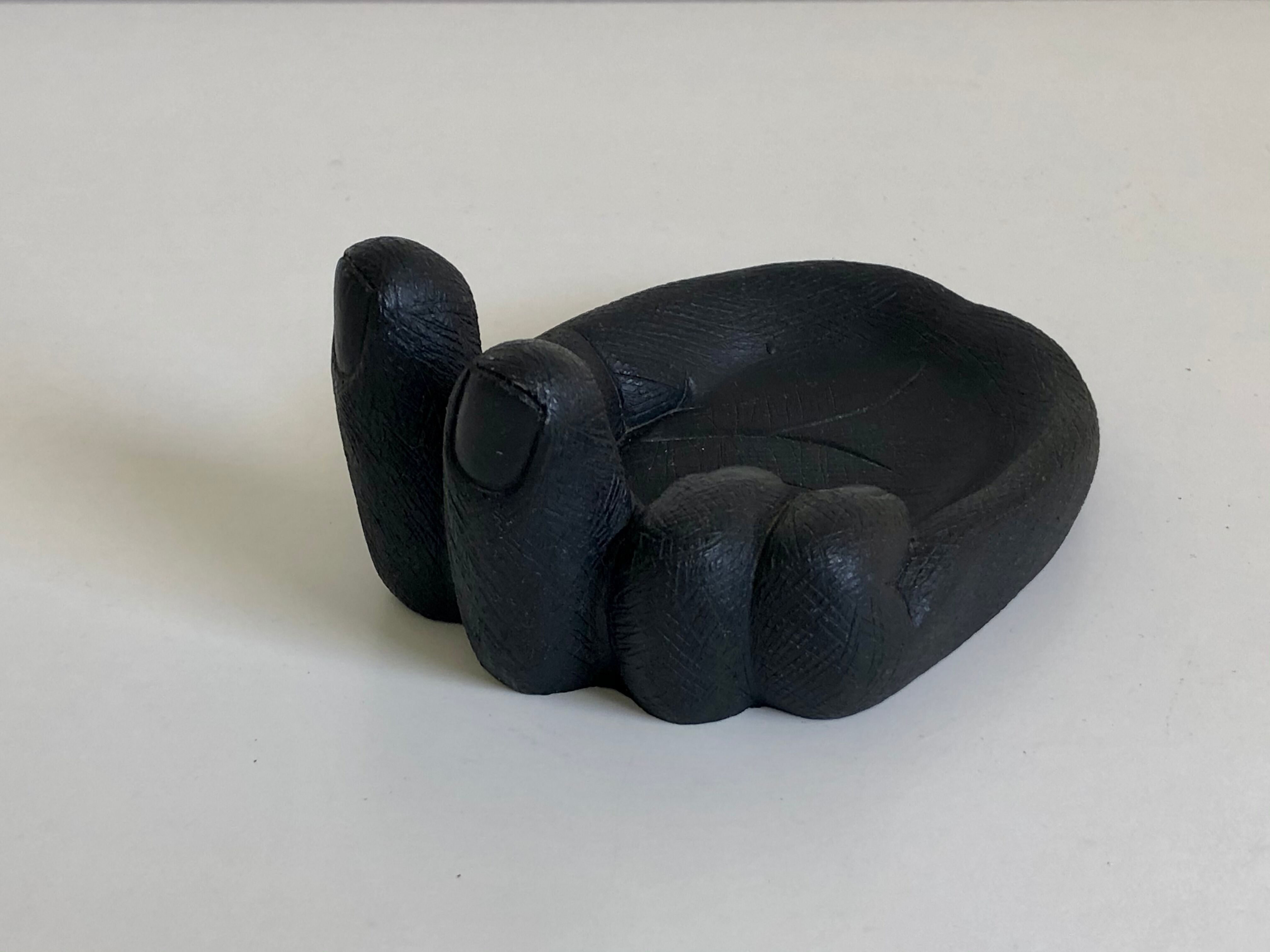 Empty pocket in Hawaiian lava in the shape of a hand signed Coco Joe, 1960