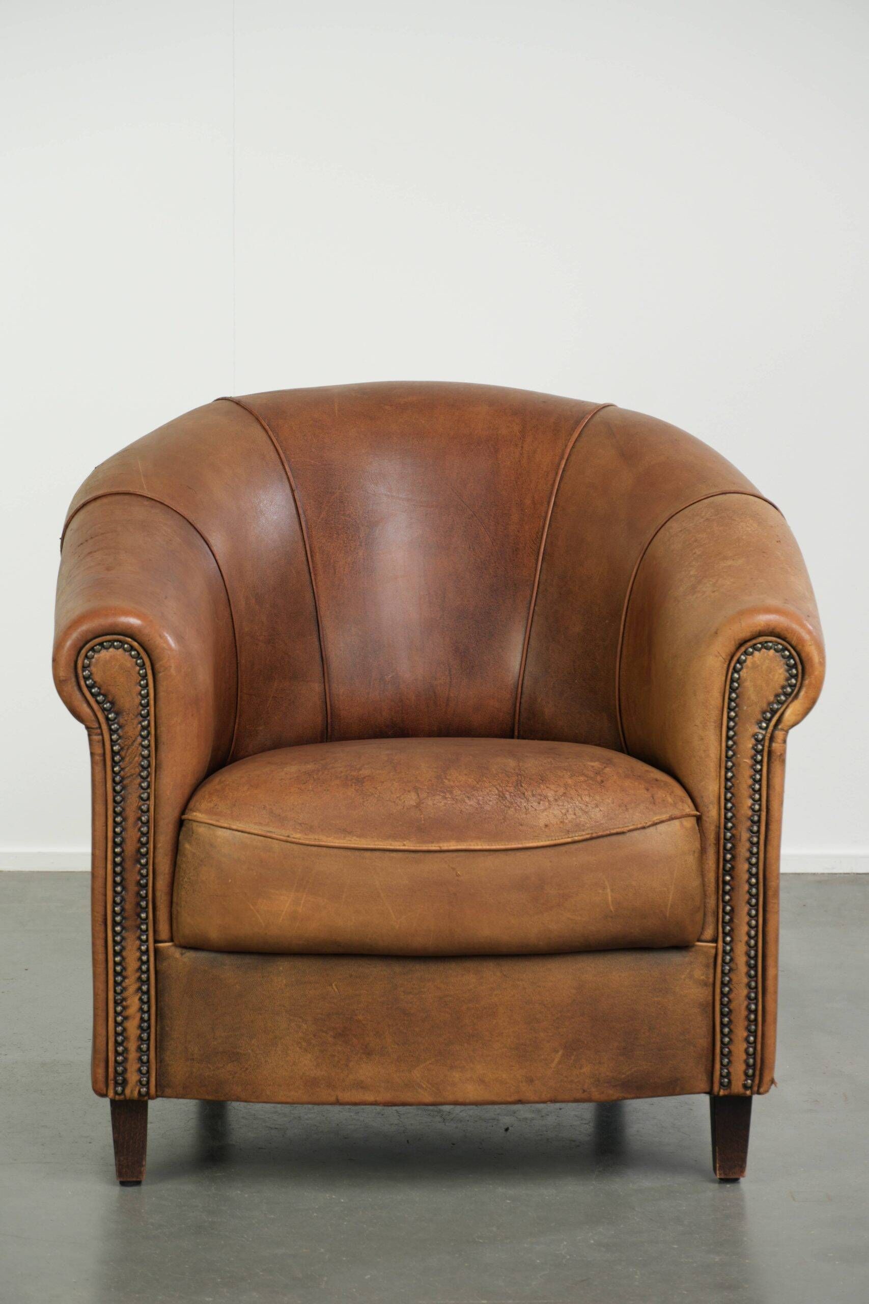 Aged sheepskin clubchair with beautiful vintage patina and comfortable seat
