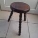 Tripod stool in dark wood. legs turned