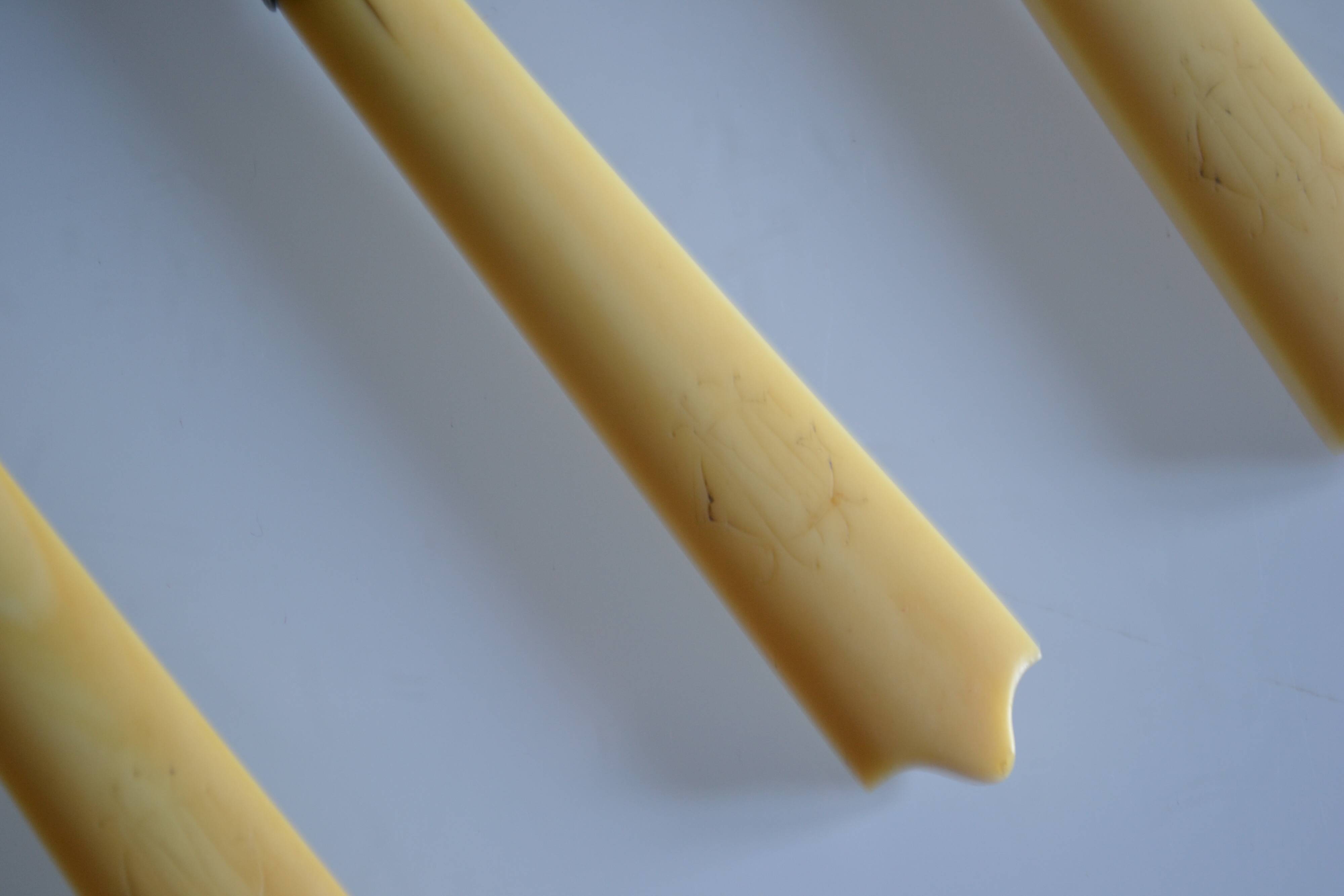 11 antique 19th-century table knives with ivory-colored monogram handles