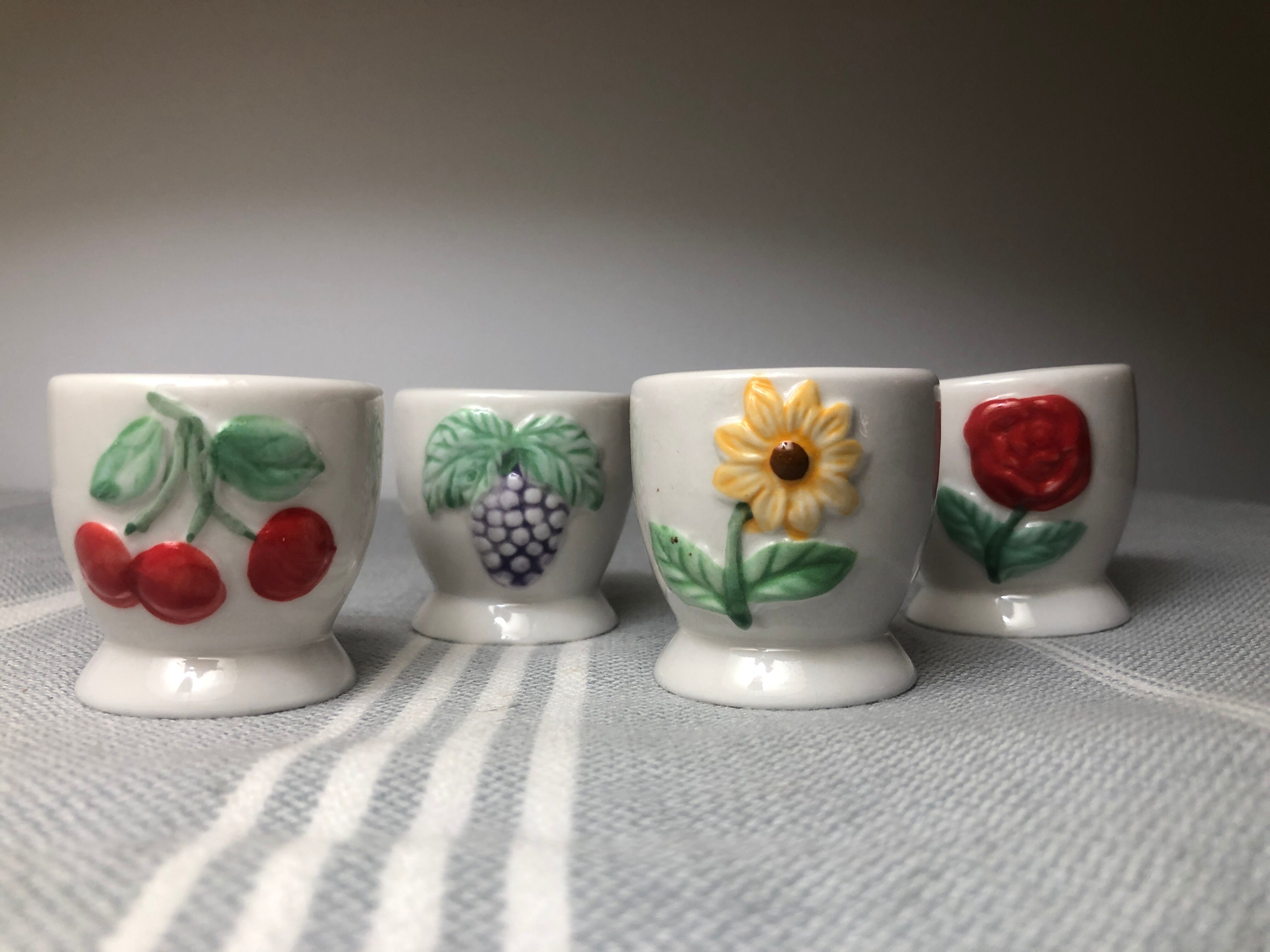 Ceramic shells with relief decoration of flowers (yellow and red) and fruits (cherries and grapes)