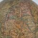 Globe on turned and blackened wooden base