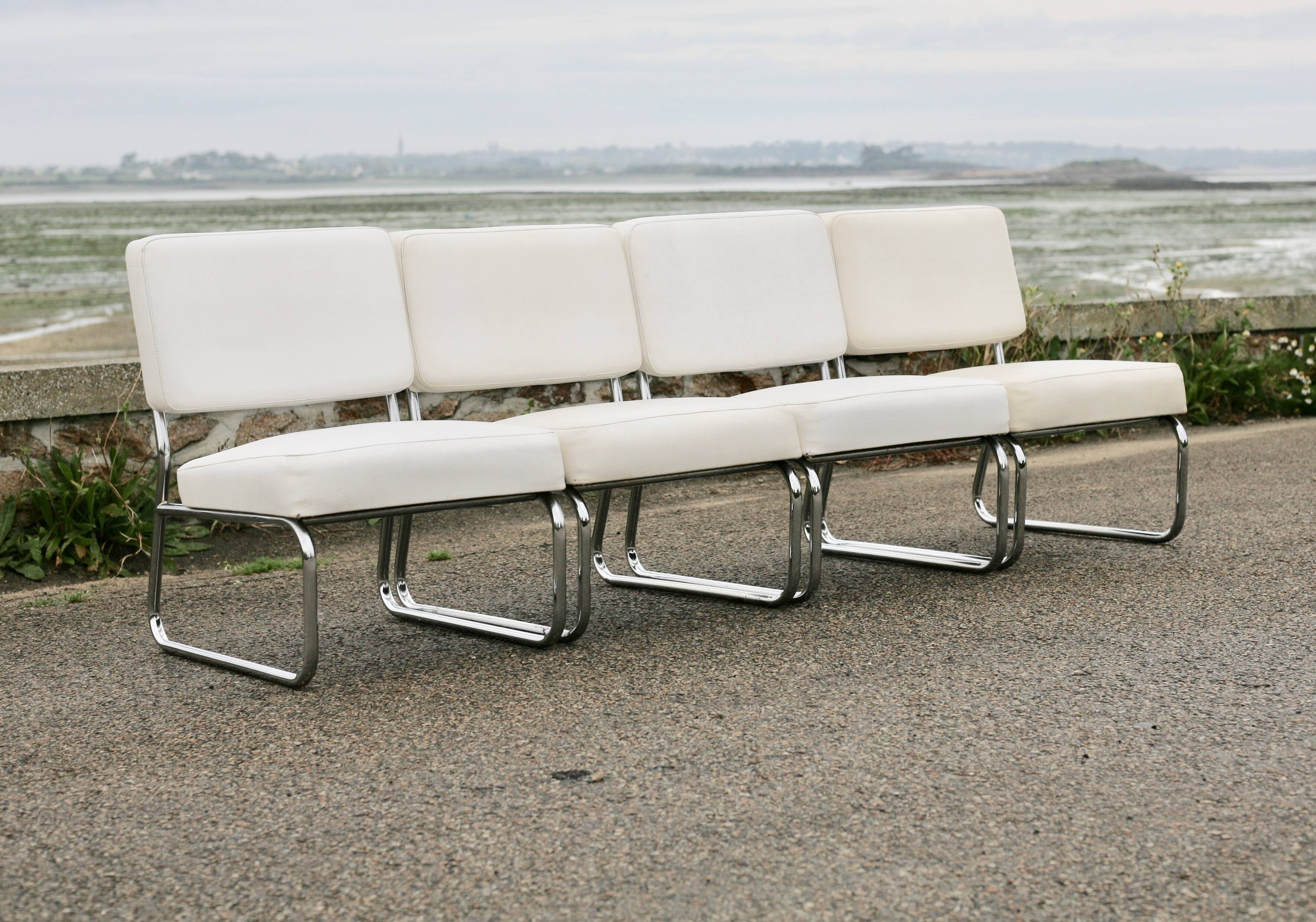 4 armchairs forming a modular sofa. Steel, imitation leather, 70s