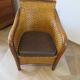Colonial style armchair in woven rattan and exotic wood
