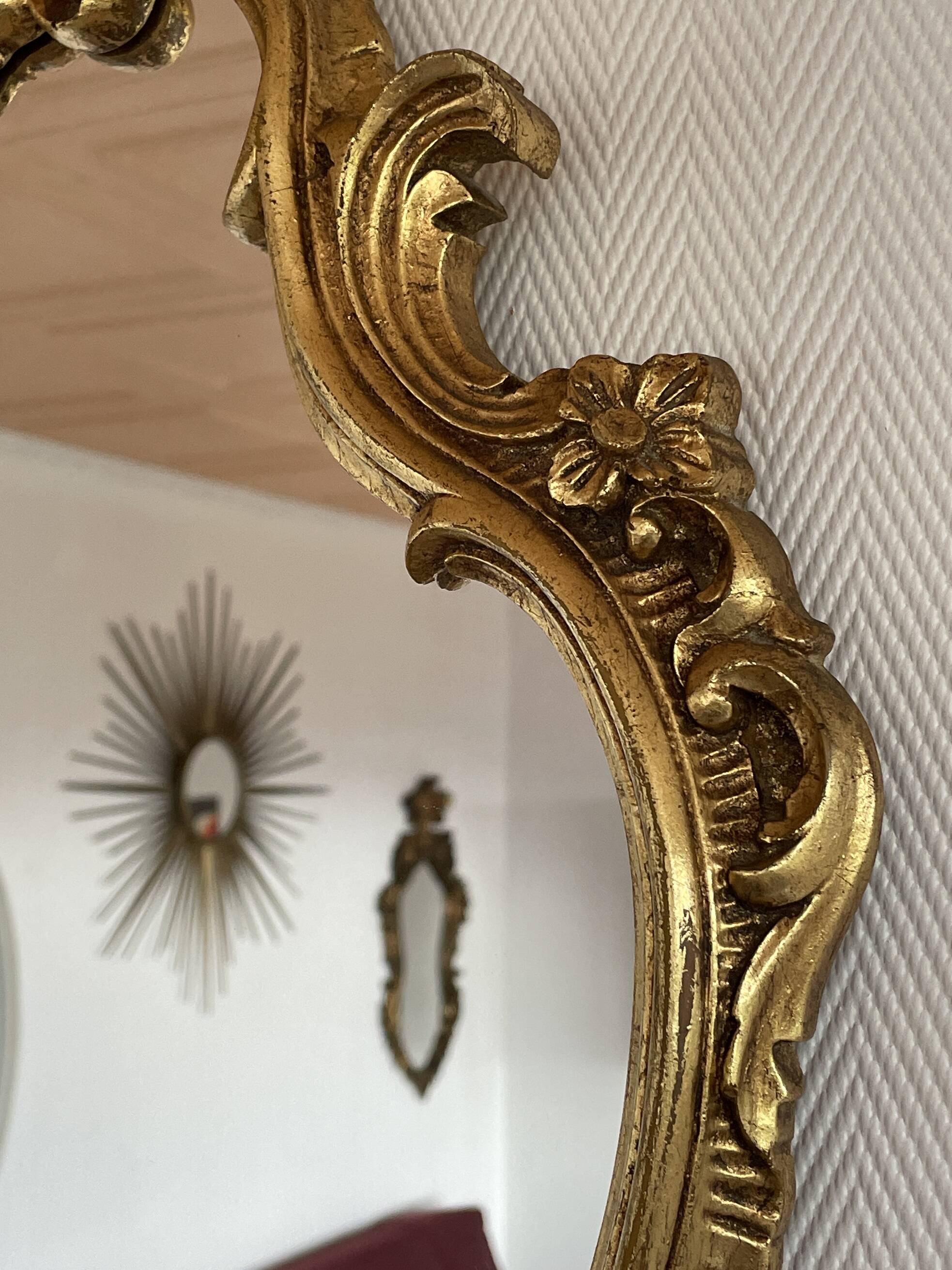 Old baroque style wall mirror with golden moldings