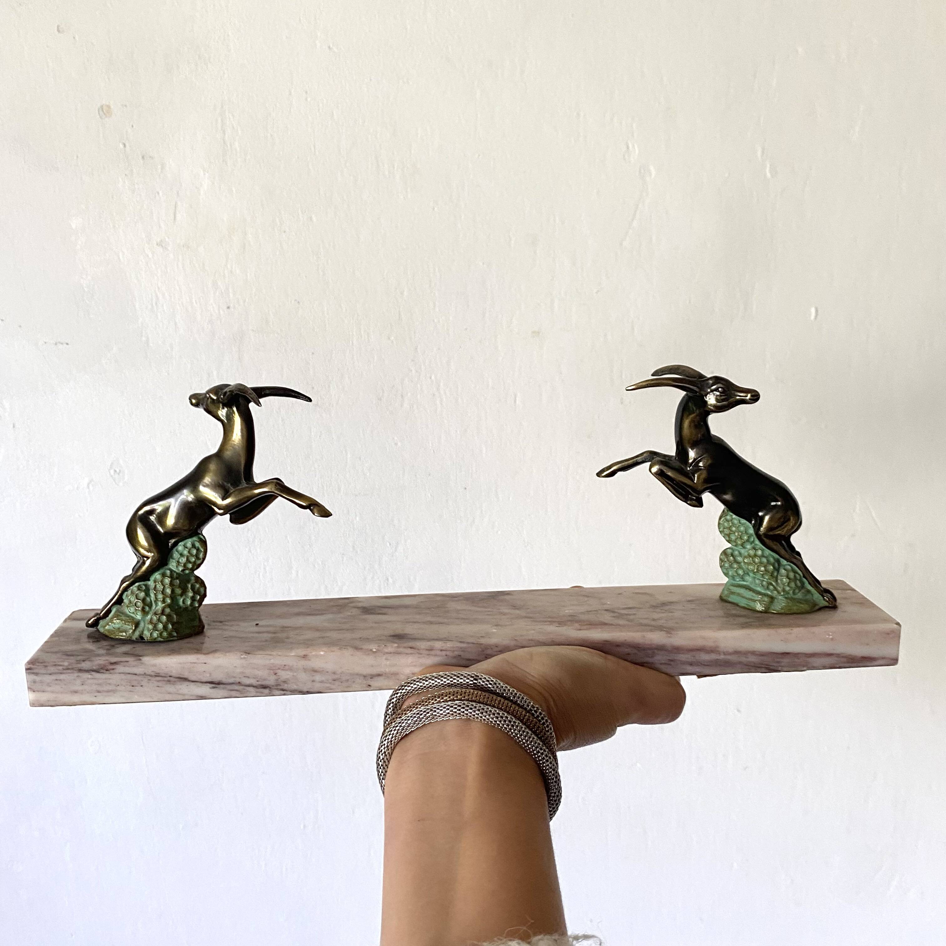 Art deco bookends in pink marble and spelters, antelopes