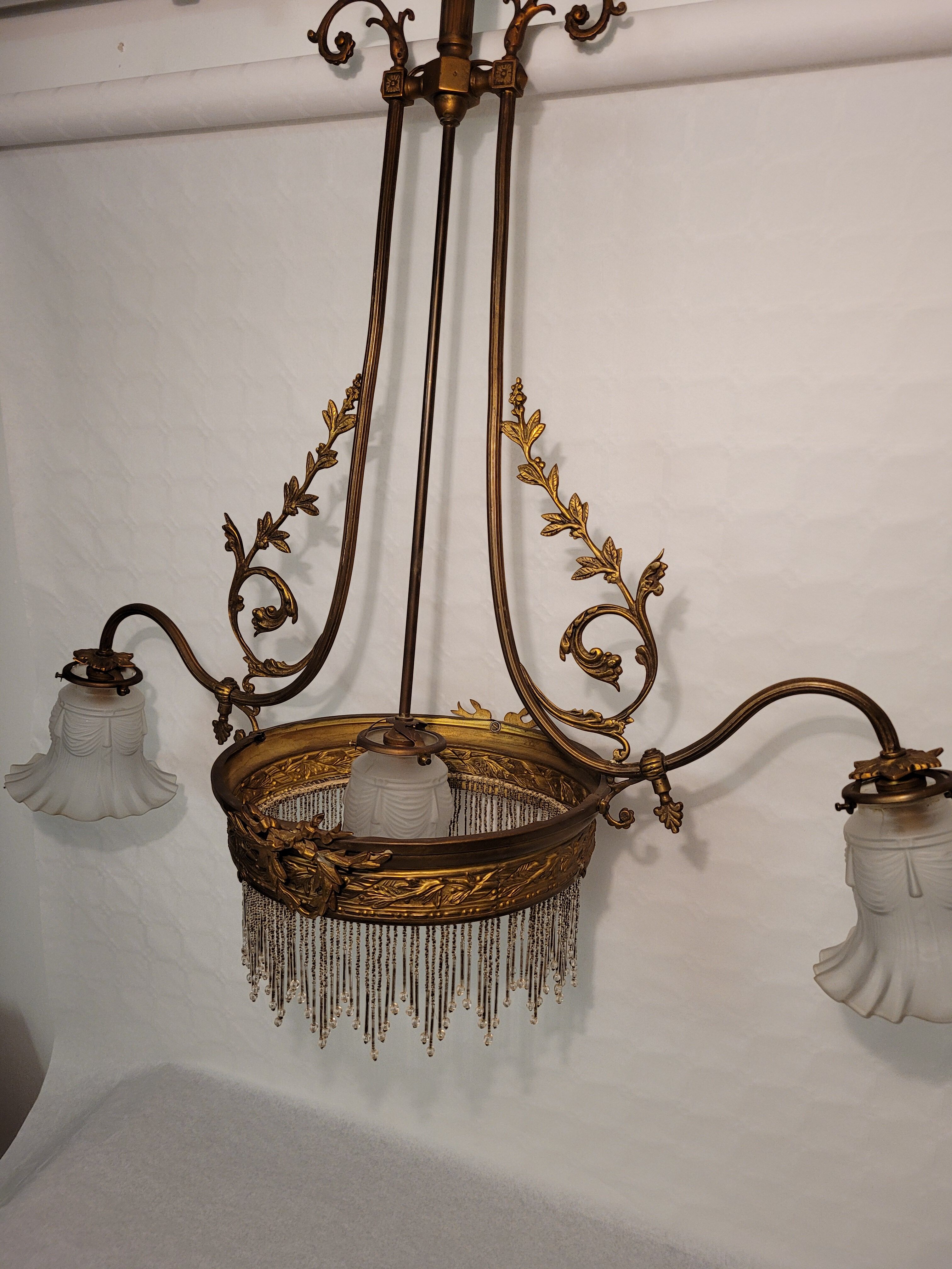 Gold metal chandelier and three-light beads