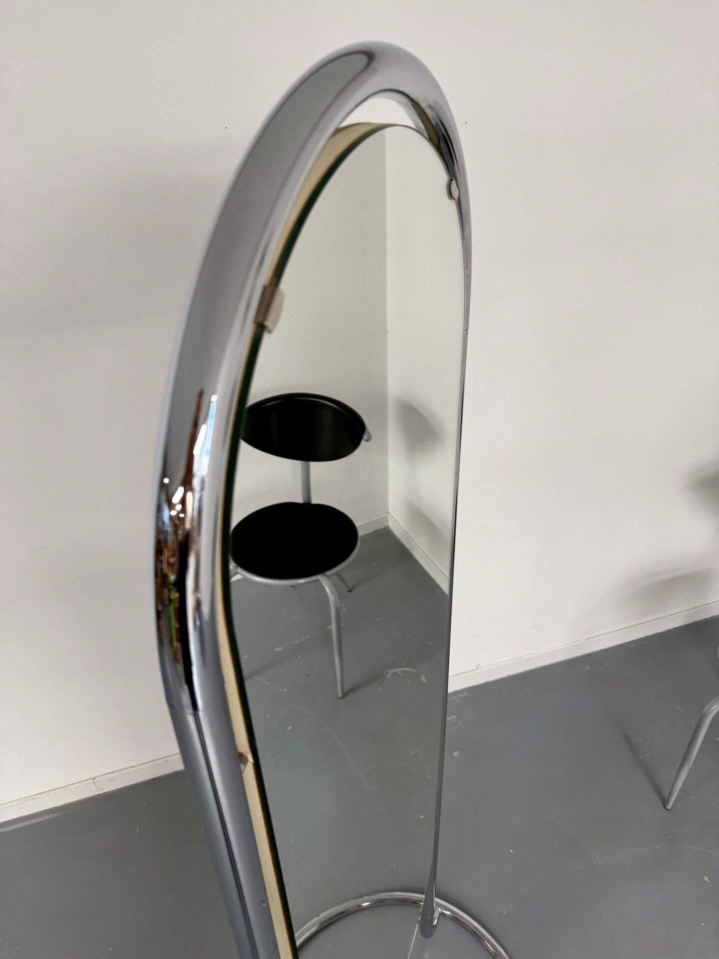 Large freestanding chrome metal full-length mirror in 1970s design.
