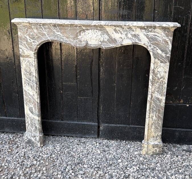 Louis XV fireplace in grey Ardennes marble, a floral basket in white marble, late 18th century.