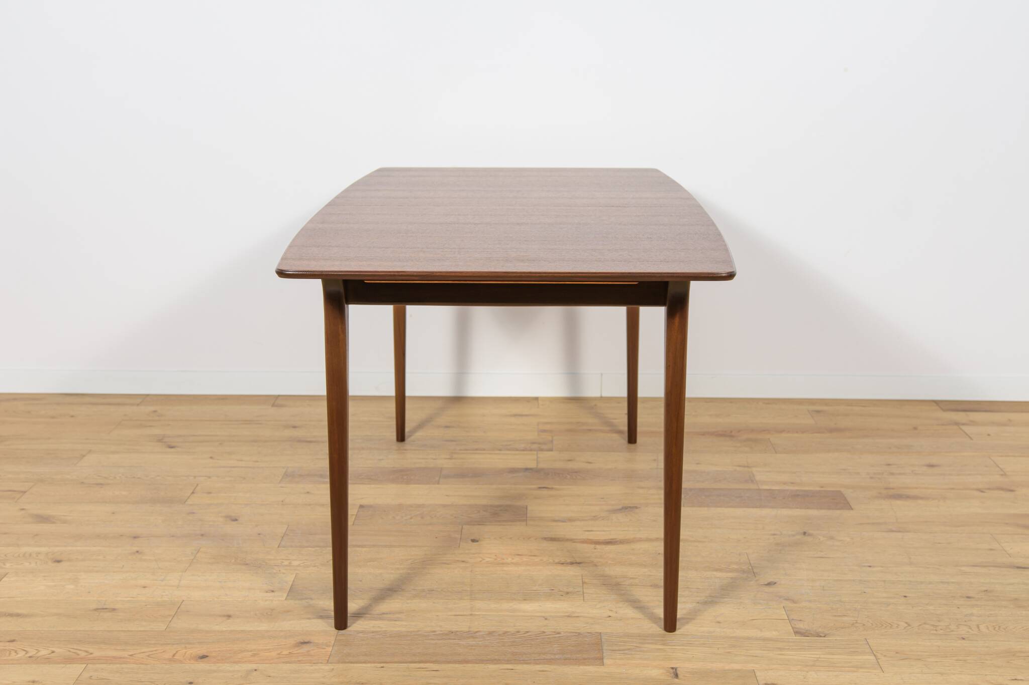 Extendable teak dining table in Mid-Century style from McIntosh, UK.